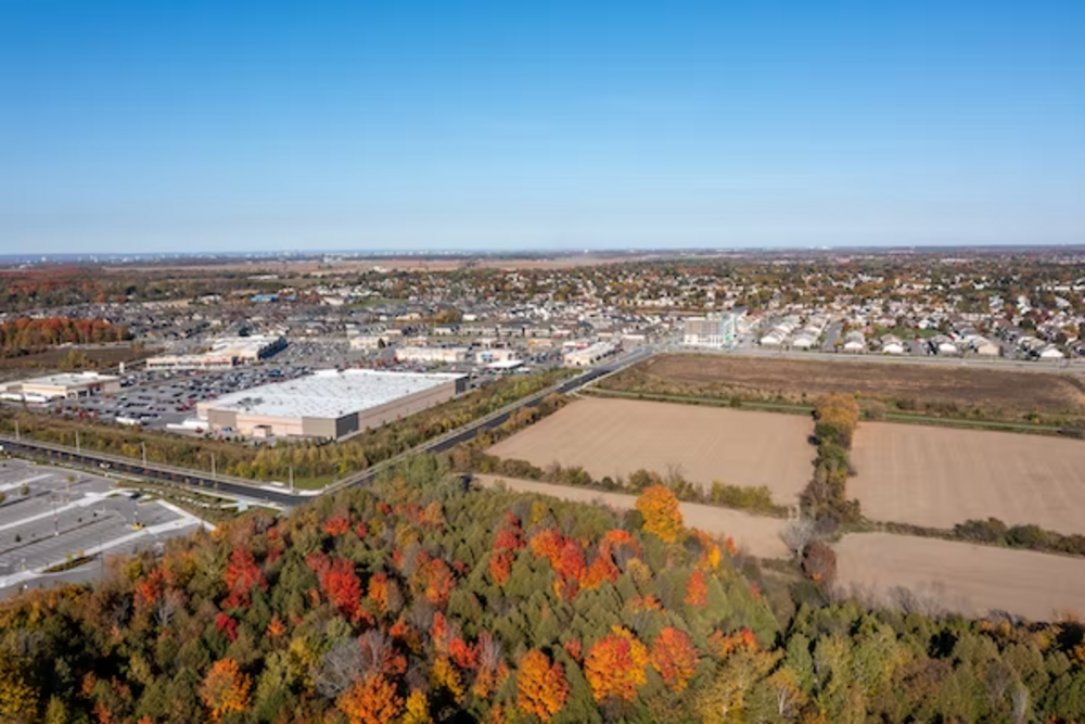 an aerial view of a commercial property next to empty plots