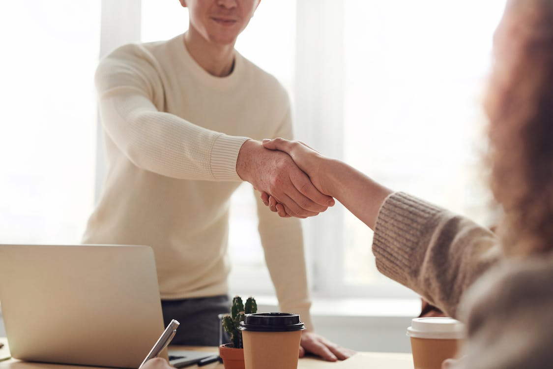  A person shaking hands with another person Build a good repo with existing and potential clients
