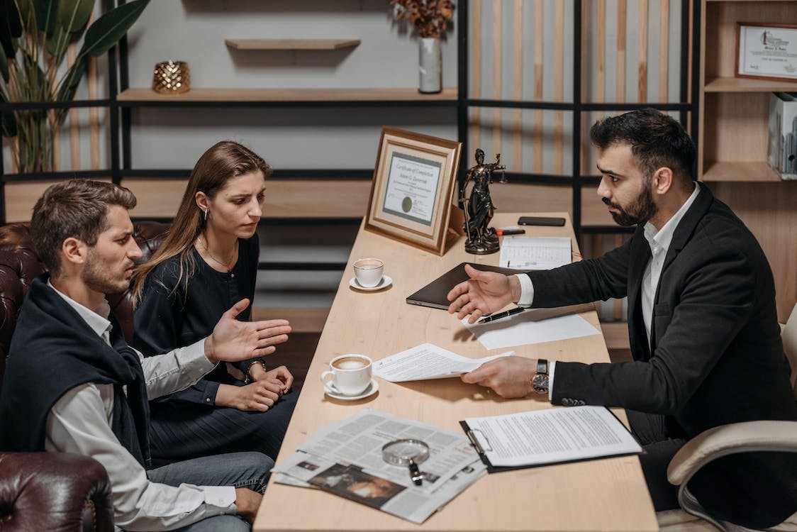 A lawyer discussing a case with a worried couple