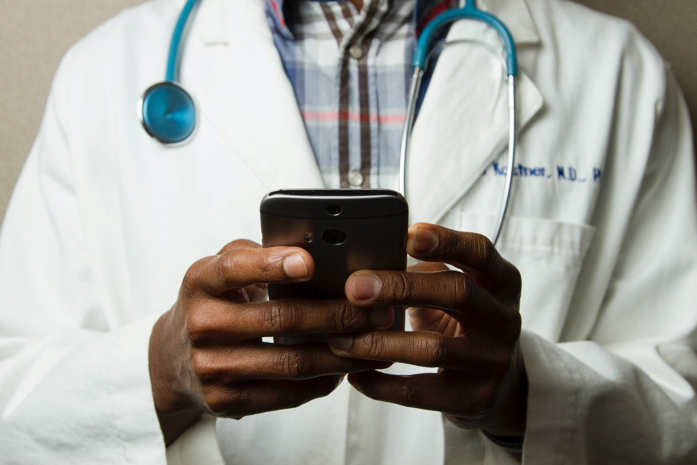A doctor using his phone for virtual healthcare