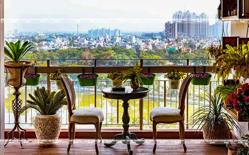 A scenic balcony with a table and chairs, providing a breathtaking view of the cityscape